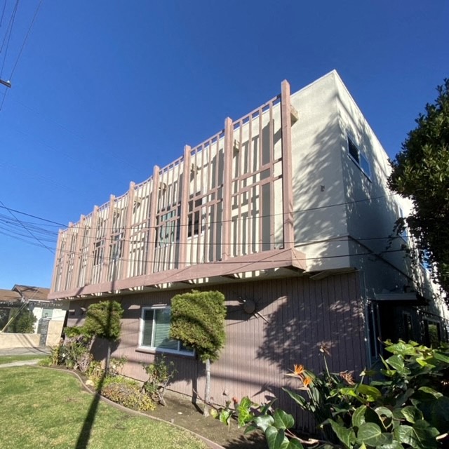 a building with a balcony and a blue sky